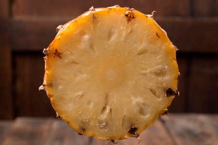 Pineapple sliced on wood background, top view, healthy fruit food concept.の写真素材
