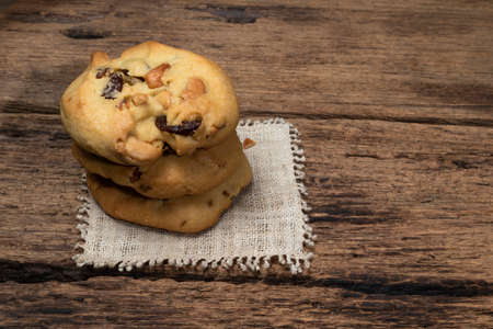 Cashew nuts raisin cookies stacked together on wood background, close up, food and drink concept.の写真素材