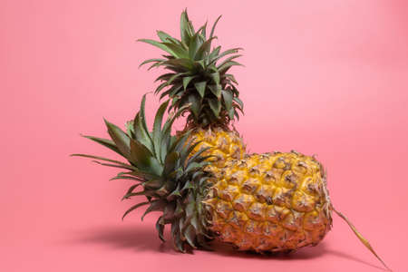 Pineapple isolated on pink background, top view, minimal healthy fruit food concept.の写真素材