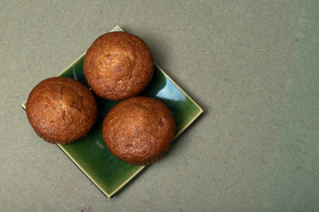 Banana cake on green wood background, top view, healthy food concept.