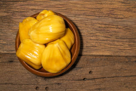 Jackfruit in bowl on wood background close up, top view, healthy food concept.の写真素材