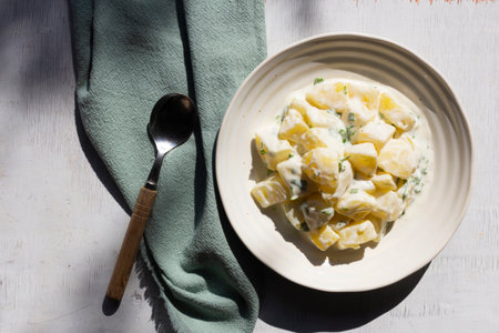 Potato salad creamy mayonnaise on wood background top view, copy space, healthy food concept.の写真素材