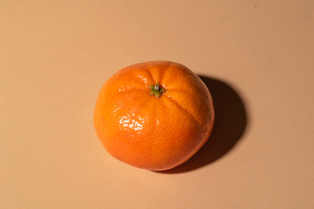 Orange fruit has leaves isolated on orange color background close up, top view, healthy food...