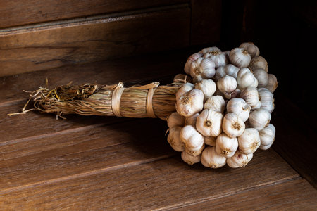 Garlic on black wood background close up, top view, healthy food concept.の写真素材