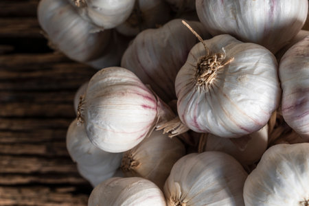 Garlic on black wood background close up, top view, healthy food concept.の写真素材