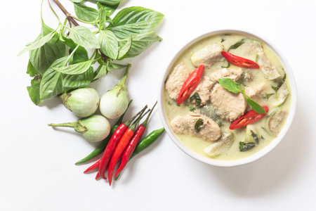 Green chicken curry has eggplant chill basil in bowl on white wood background, top view, Asian food concept.の写真素材
