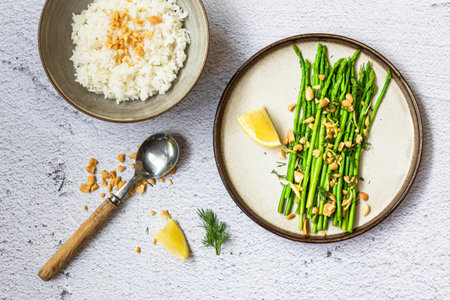 Asparagus salad with peanuts dill lemon has rice on white background top view, healthy vegan food concept.の写真素材