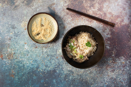 Tuna salad mayonnaise sesame has brown rice in black bowl on metal background, top view, healthy food concept.の写真素材