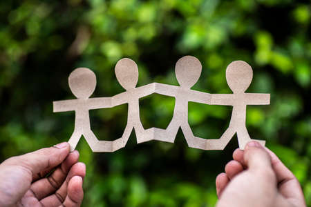 paper people holding hands on natureの写真素材