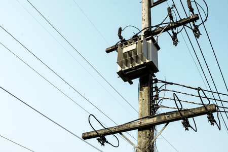 Transformer transmission electricity convert high voltage to low voltage, Power supply transformer reduce voltage, Electricity pole in rural countryside, Distribution Transformer reduction on blue skyの写真素材