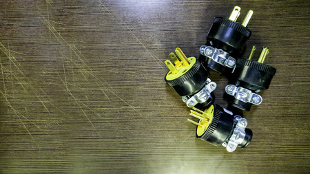 Top view of electric plug on wooden background, Selective focus electricity plug on table, Close up...