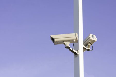 Closeup of traffic security camera on blue sky, Camera surveillance monitoring (CCTV)