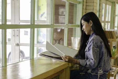 Beautiful asian girl are thinking of something in Cafe, Woman are relaxing in the restaurantの写真素材