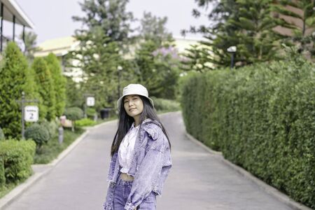 Beautiful asian girl with green brush of treeの写真素材
