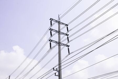 Electricity pole against blue sky clouds, Transmission line of electricity to rural, High voltage electricity pole on bright sky clouds backgroundの写真素材