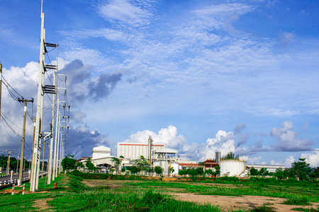 Electricity power substation with factory building for industrial backgroundの写真素材