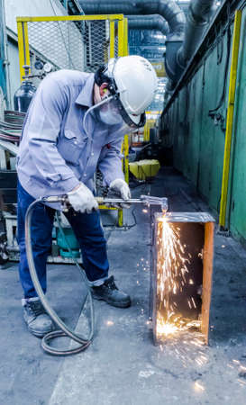 Technician are using gas to cut metal part, Gas cutting operation, Worker work in construction site,...