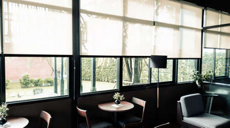 Green nature beside the window, coffee bar, peaceful place for take a rest in the morning, Flare light through the window in the morningの写真素材
