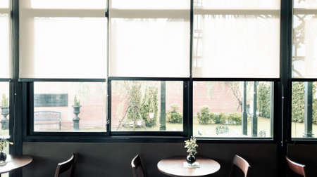 Green nature beside the window, coffee bar, peaceful place for take a rest in the morning, Flare light through the window in the morningの写真素材