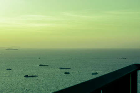 Balcony view Of Sea with boat and sunset skyの写真素材