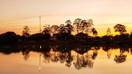 Orange sunset sky with shadow of tree over river, Silhouette sky clouds backgroundの写真素材