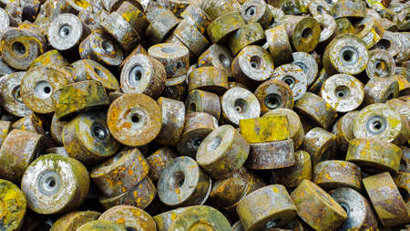 A pile of rusted dies and moles that have passed a steel wire drawing process, rust on ferrous...
