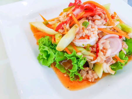 Thai food spicy seafood and pork salad with vegetable on white plateの素材