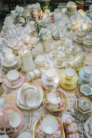 Antique porcelain pastel tea cup on wooden tableの写真素材