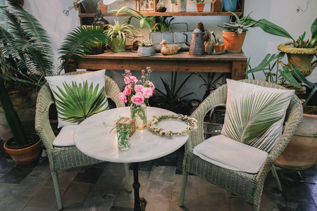 Living room with comfortable sofa and wooden furniture. Decorated in hipster summer cozy stylish.の写真素材