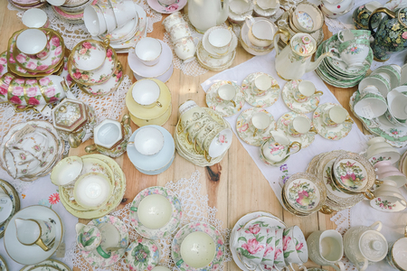 Antique porcelain pastel tea cup on wooden tableの写真素材