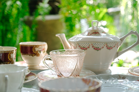 Antique porcelain pastel tea cup on wooden tableの写真素材