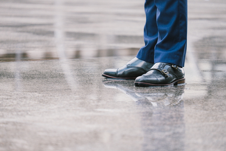 business man in suit stand on the wet floor after rainの写真素材