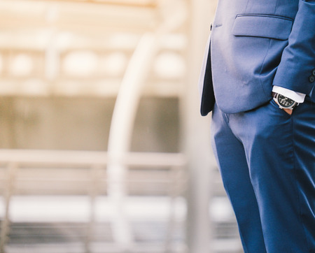 business man hand in pocket with wrist watch in a business suit close upの写真素材