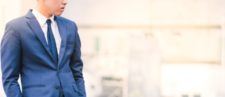 asian business man in suit on a cityscape backgroundの写真素材