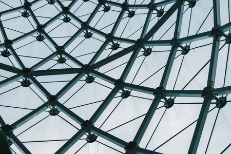 Structural glass facade curving roof of fantastic office building. Modern and Contemporary architectural fiction with glass steel column.Abstract architecture fragment.の写真素材
