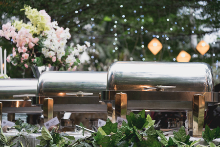 buffet food in the  luxury restaurant garden with flower and leaf decorationの写真素材