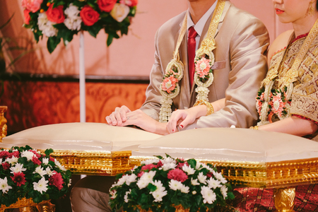 Groom and bride in traditional Thai wedding ceremony. Prepare for Hands pouring blessing water.の写真素材