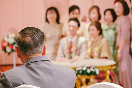 Bride's Father look at bride and groom in Thai traditional wedding. Family conceptの写真素材
