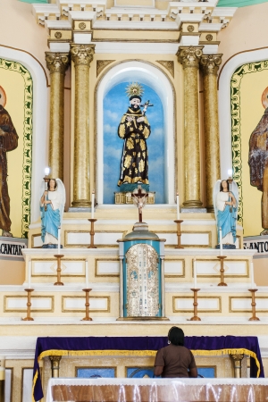 Basilica of San Francesco, woman in prayer in Caninde, Ceara State, Brazilのeditorial素材