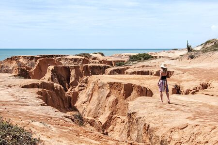 FORTALEZA, CEARA STATE, BRAZIL - JUN 19: Young woman on the rocky beach of Morro Branco on June 19 2011, in Fortaleza, Ceara State, Brazilのeditorial素材