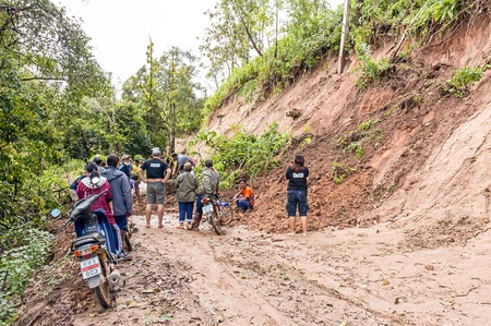 CHIANG MAI, THAILAND - OCTOBER 4  Peoples help together clear tree and soil on local road because of...