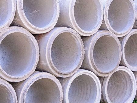 Concrete drainage pipes stacked on construction site