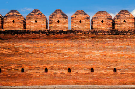 Brick wall of the ancient on blue skyの写真素材