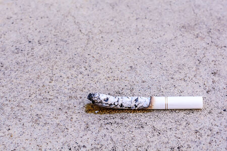 Cigarette butt was left on the floorの写真素材