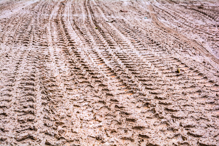 Tire tracks on a muddy road in the countryside  の写真素材