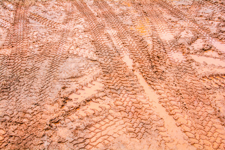 Tire tracks on a muddy road in the countryside  