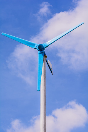 Wind power generators with white cloud on blue sky.の写真素材