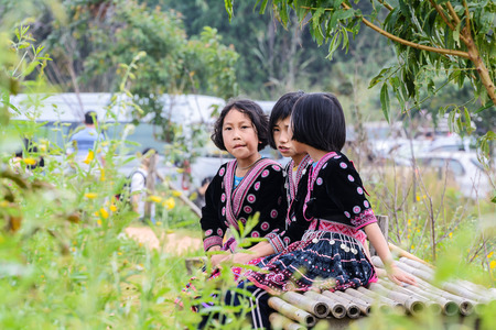 CHIANG MAI, THAILAND - OCTOBER 18 : Unidentified Hmong children wait for tourists to take pictures at Mon Cham on October 18, 2014, Chiang Mai,Thailand. Mon Cham is a tourist attraction in Chiang mai.のeditorial素材