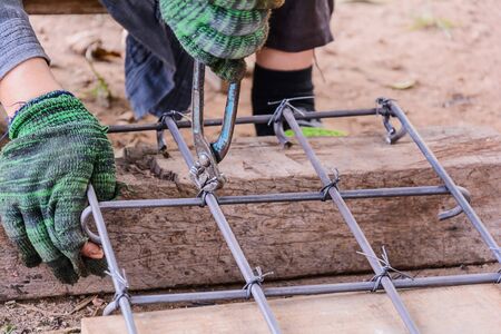 Worker working wire tied with rebar for reinforced concrete.の写真素材