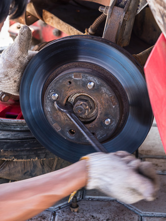 Mechanic technician worked replacing brakes vehicle of automobile at repair service station.の写真素材